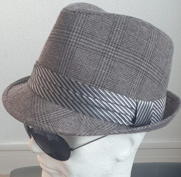 3.1 Chapeau classique Borsalino avec relevé arrière. Modèle petit bord sur ton gris chic et élégant. Sa matière en polycoton assurera un agréable confort. Un ruban décoratif monochrome placé à la base de la calotte ajoute assurément à la l'esthétisme de ce couvre-chef.